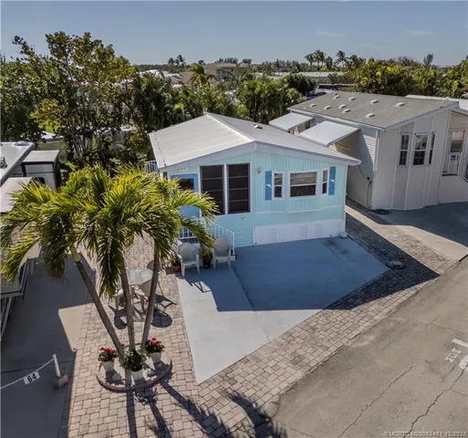 a view of a house with yard and sitting area
