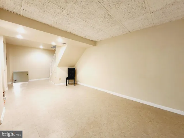 a view of backyard with wooden fence