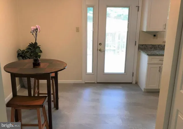 a view of an empty room with chandelier and a window