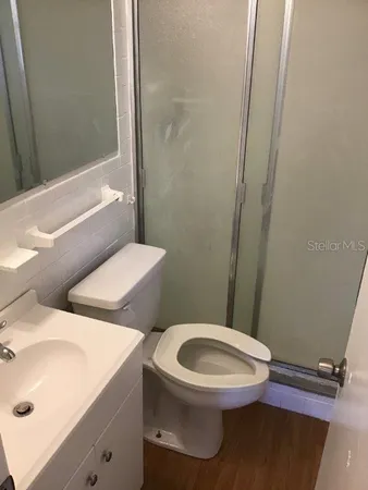 a white toilet sitting next to a bathroom sink