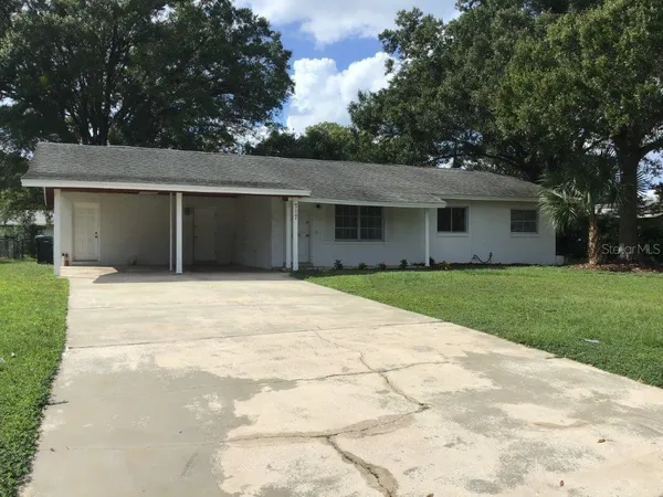 a front view of house with yard and trees