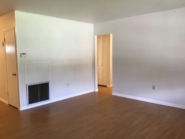 an empty room with wooden floor