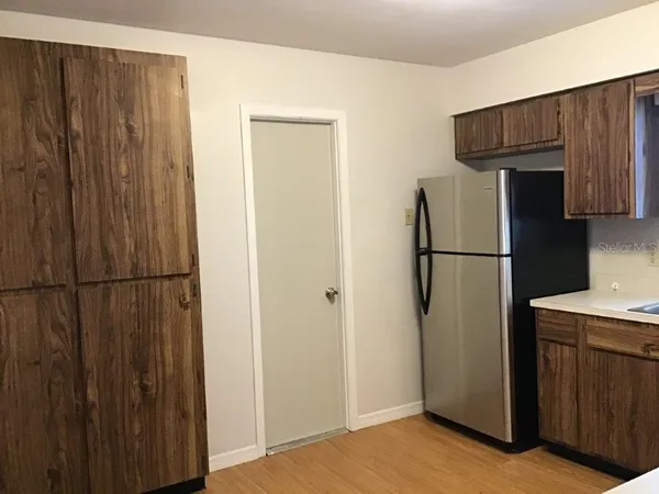 a view of a kitchen with refrigerator and cabinet