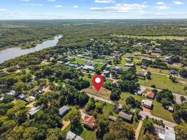 an aerial view of a house with a garden and lake view