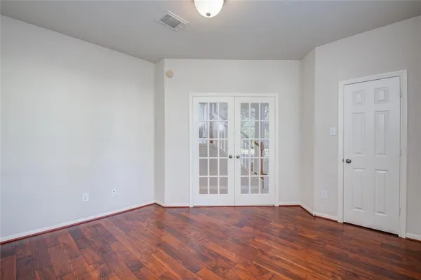 a view of a livingroom with wooden floor and a chandelier