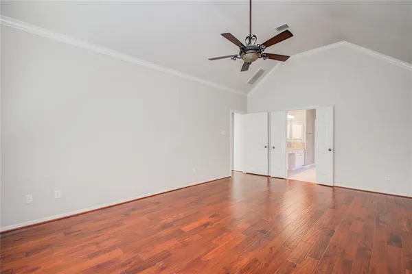 a view of a livingroom with wooden floor and a ceiling fan