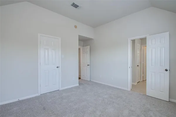 a bathroom with a granite countertop toilet sink and mirror
