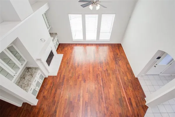 a view of a hallway with wooden floor and stairs