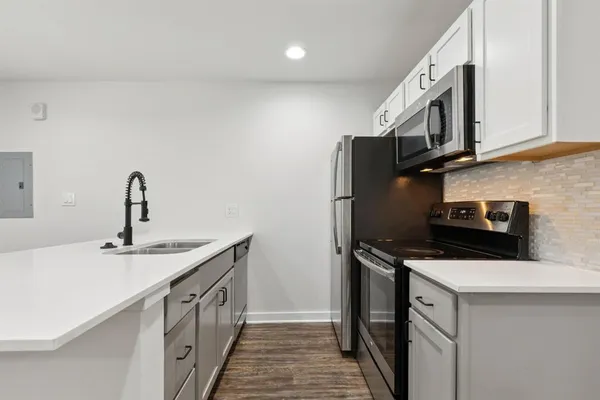 a kitchen with stainless steel appliances a sink stove and cabinets