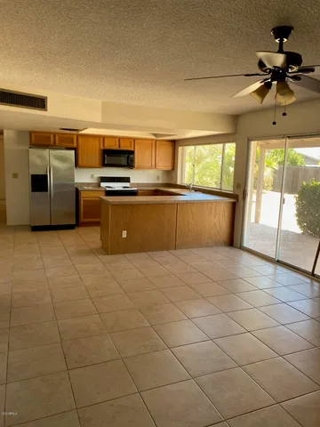 a kitchen with stainless steel appliances granite countertop a sink and a refrigerator