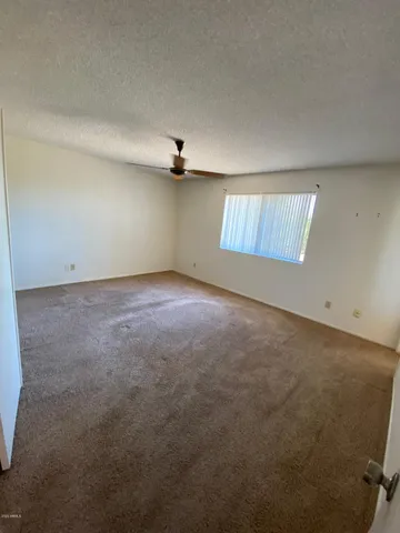 an empty room with a empty space and windows