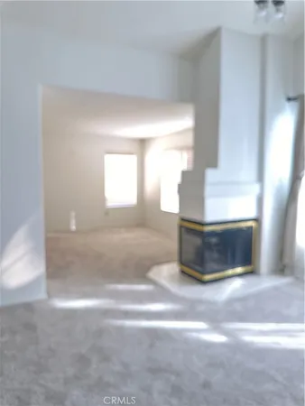 a view of a room with a chandelier fan and windows