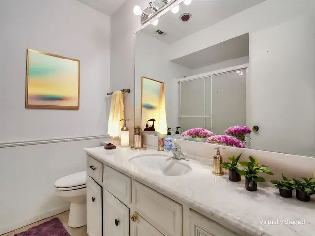 a bathroom with a toilet sink and mirror