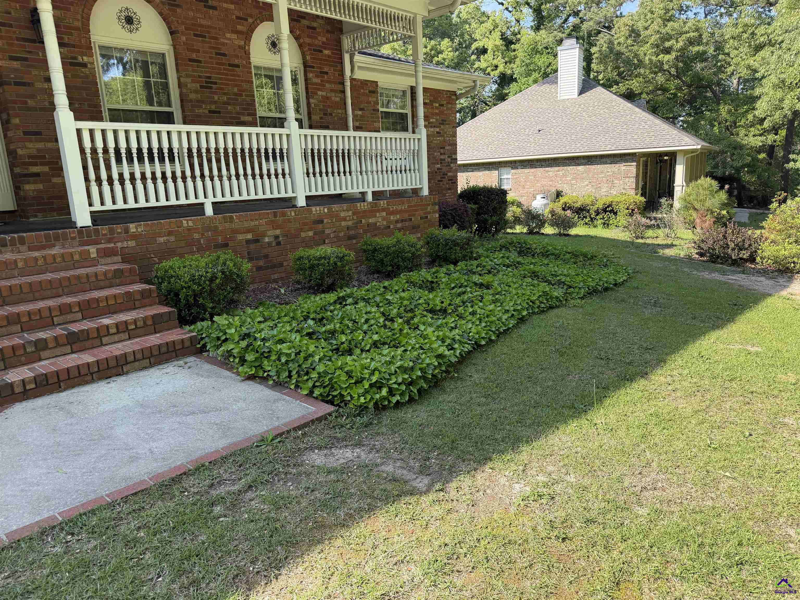 249 Hatcher Road Warner Robins, GA 31088 - Photo 3 of 25 a view of a house with a yard and table and chairs under an umbrella