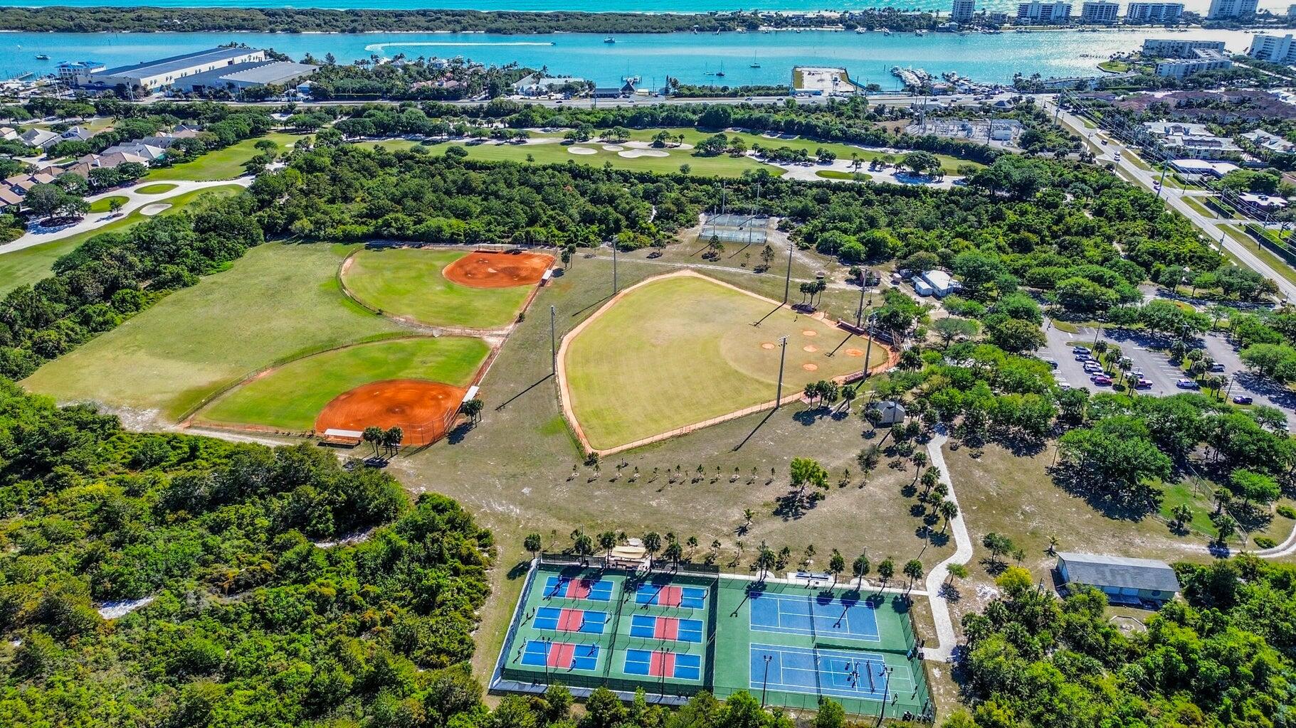 3900 County Line Road, Unit 26C Tequesta, FL 33469 - Photo 12 of 12 an aerial view of a house with a swimming pool a yard and outdoor seating