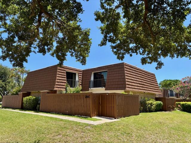 3900 County Line Road, Unit 26C Tequesta, FL 33469 - Photo 3 of 12 a view of a house with a yard
