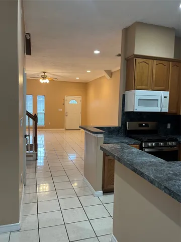 a kitchen with stainless steel appliances granite countertop a sink and a stove