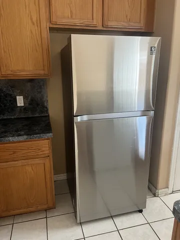 a close view of a refrigerator stove and cabinets
