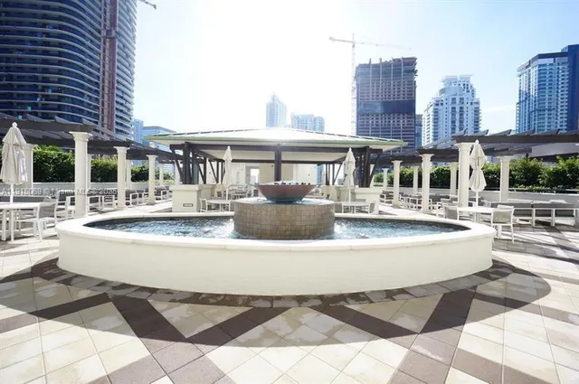a view of swimming pool with outdoor seating and city view
