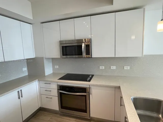 a kitchen with a sink and cabinets