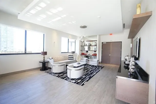 a living room with furniture and a large window