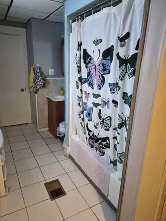 a bathroom with a bathtub and shower