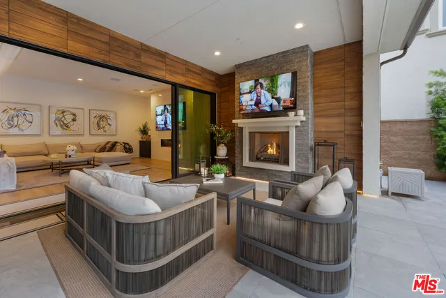 a large kitchen with stainless steel appliances kitchen island a large counter top and a wooden floors