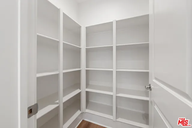 a big room with wooden floor and windows