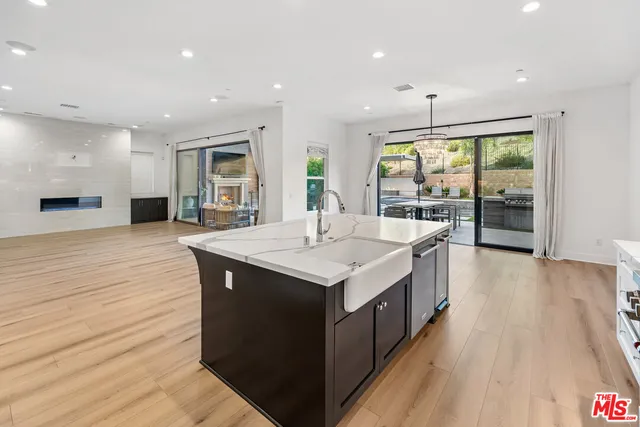 a living room with fireplace furniture and a large window