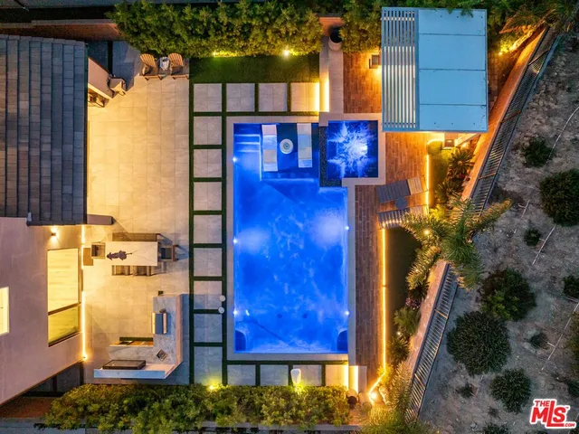 a bathroom with a double vanity sink a mirror and a bathtub