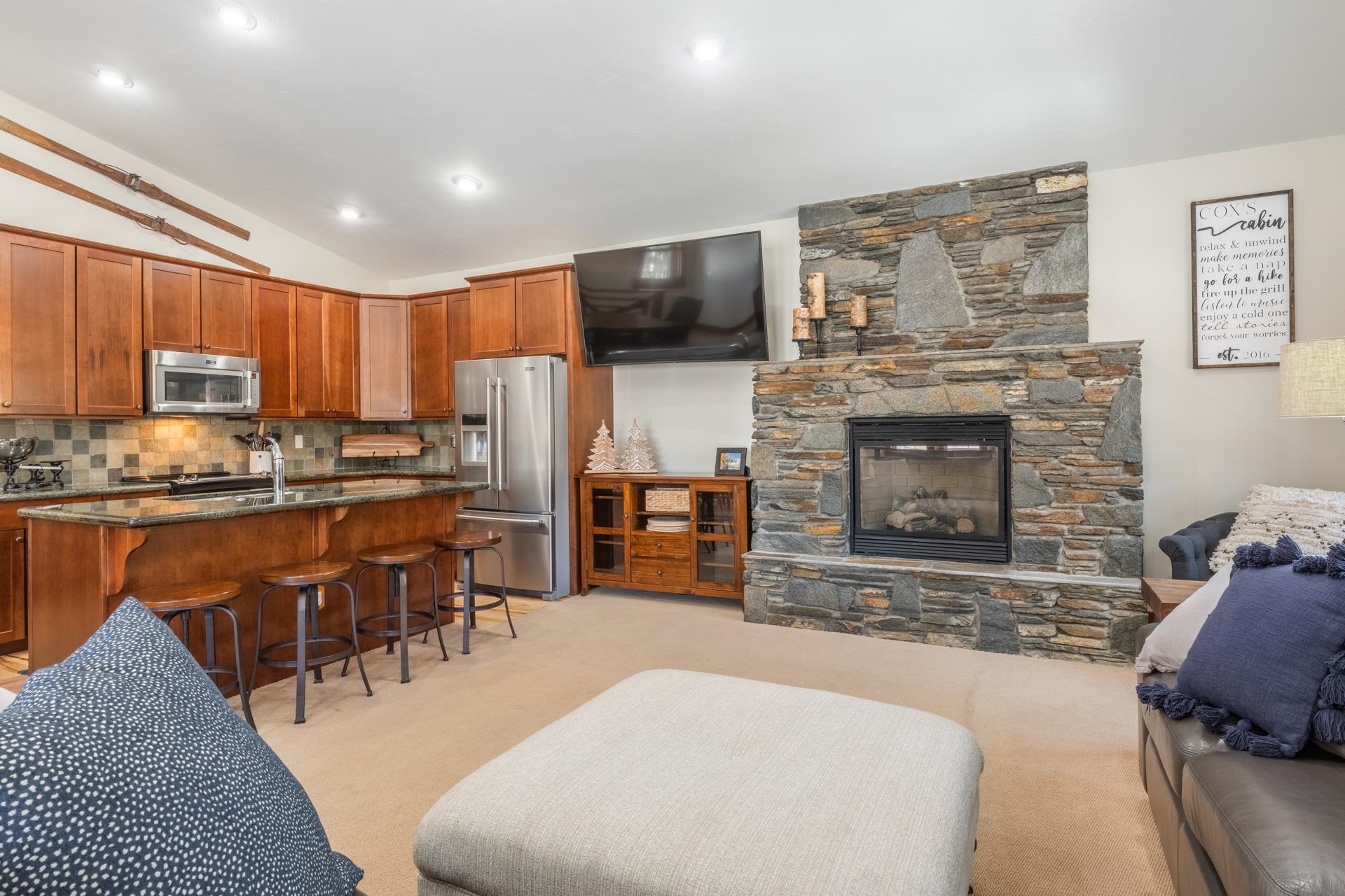 125 Davison Road, Unit 1 Mammoth Lakes, CA 93546 - Photo 14 of 46 a living room with stainless steel appliances furniture a fireplace a flat screen tv and a kitchen view