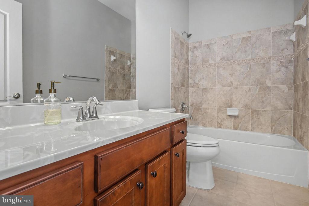 137 Silver Maple Road Middletown, DE 19709 - Photo 13 of 21 a bathroom with a granite countertop sink a toilet and shower