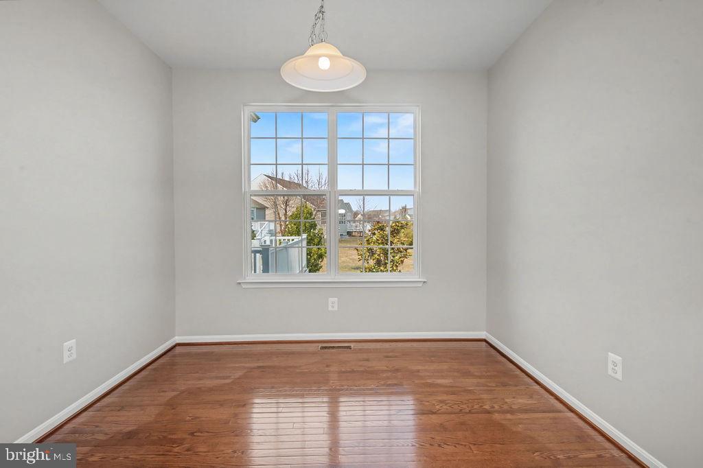 137 Silver Maple Road Middletown, DE 19709 - Photo 7 of 25 an empty room with wooden floor and window