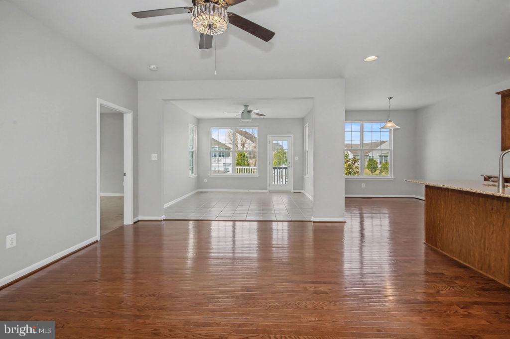 137 Silver Maple Road Middletown, DE 19709 - Photo 9 of 25 a view of an empty room with a window and wooden floor
