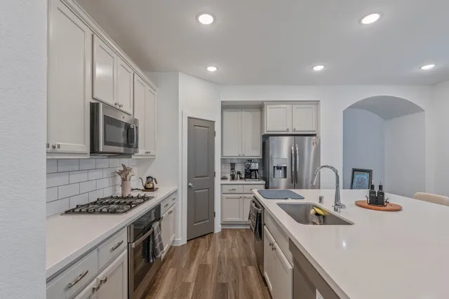 a kitchen with a sink stove and refrigerator