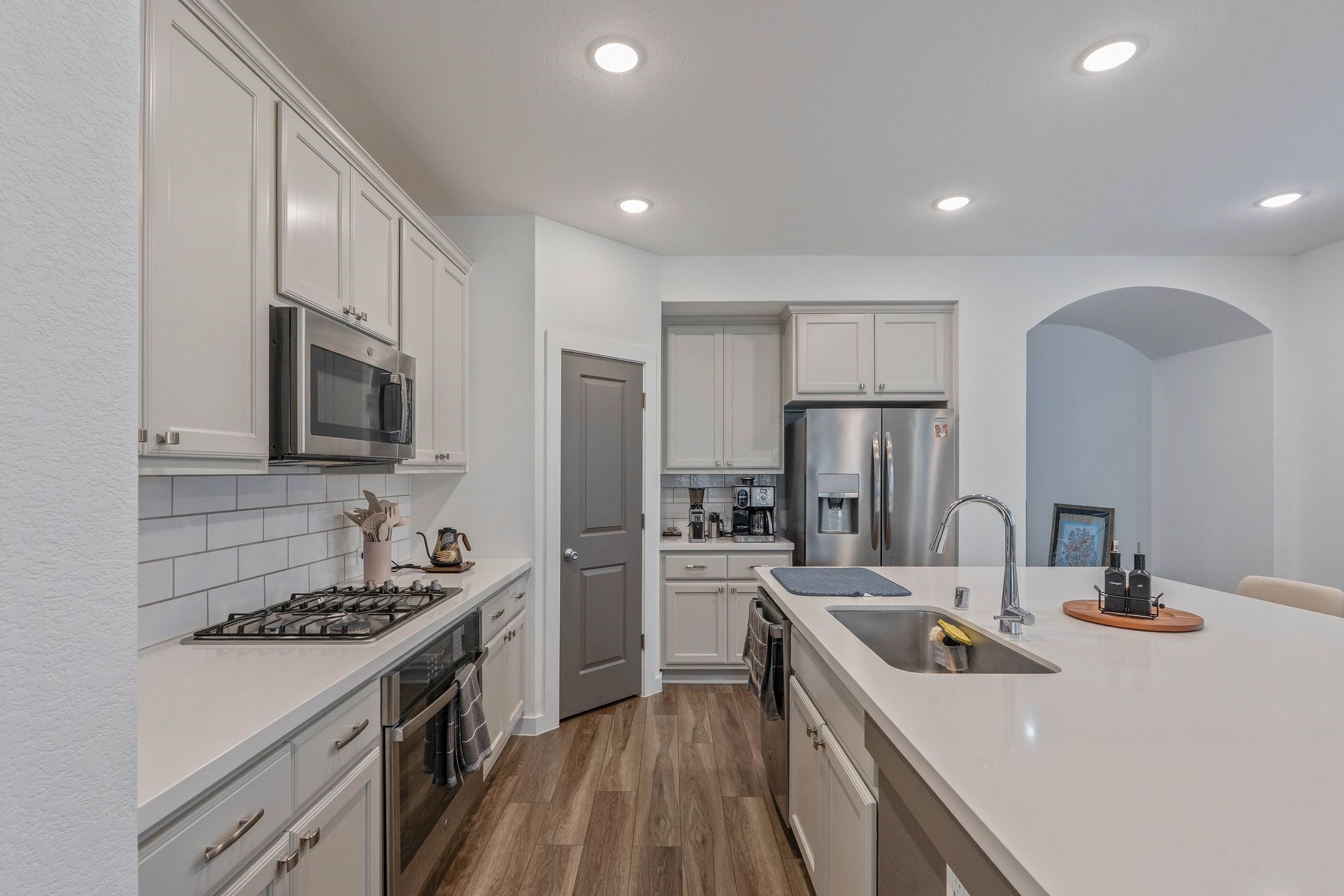 509 Timber Voyage Court Conroe, TX 77304 - Photo 11 of 36 a kitchen with a sink stove and refrigerator
