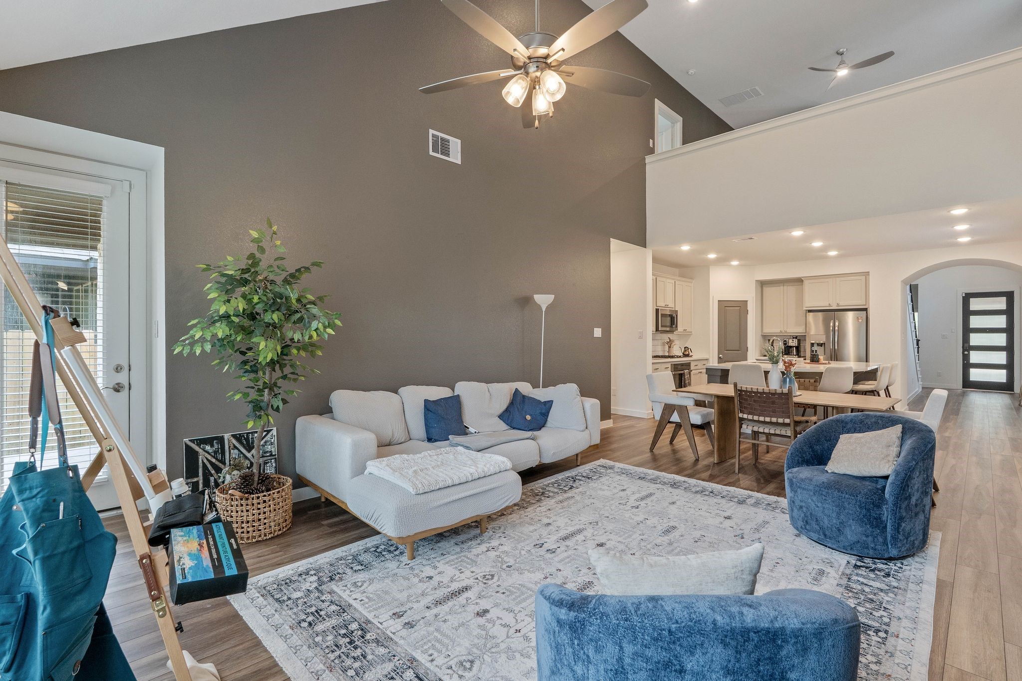 509 Timber Voyage Court Conroe, TX 77304 - Photo 17 of 36 a living room with furniture and a chandelier
