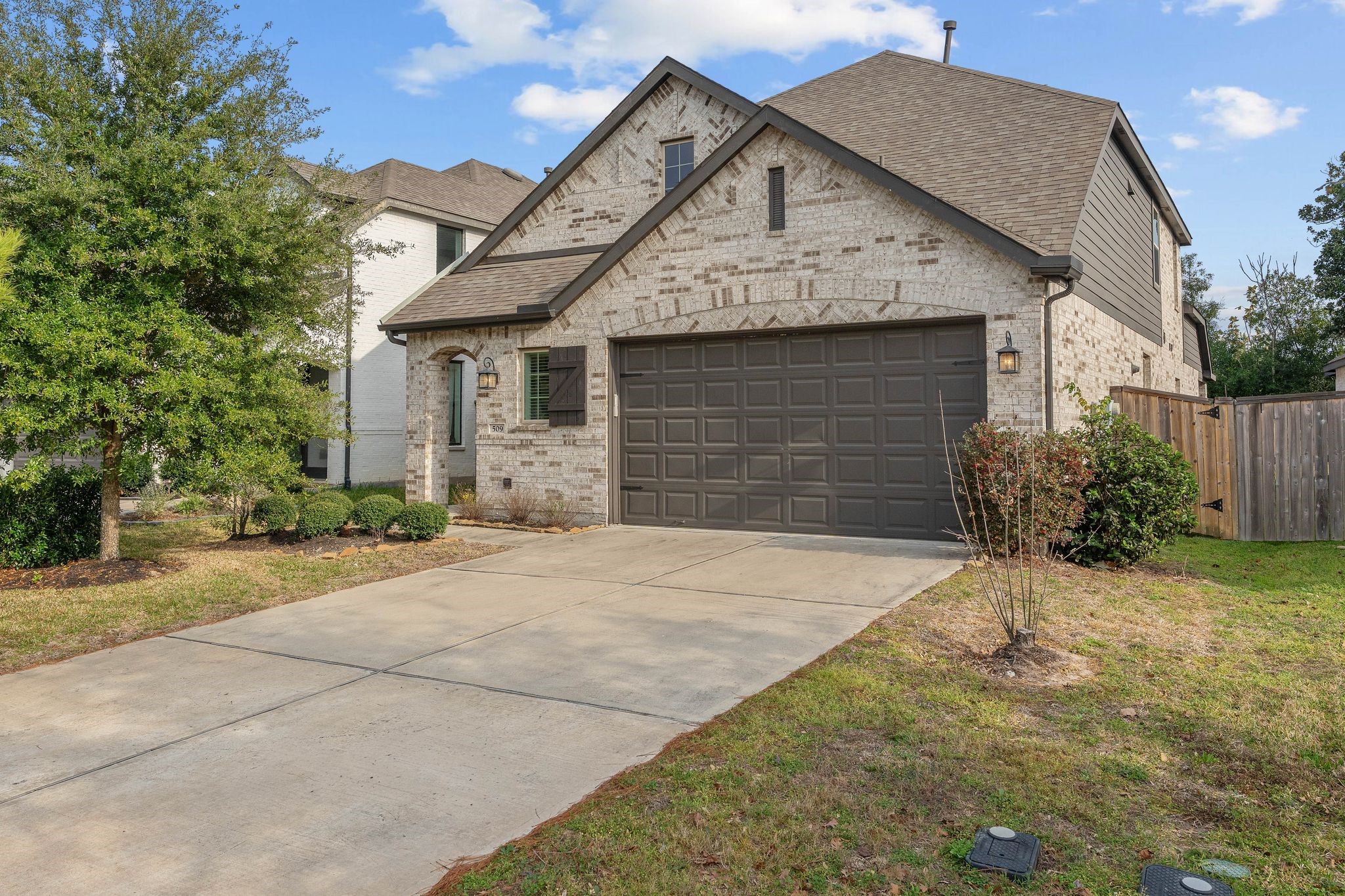 509 Timber Voyage Court Conroe, TX 77304 - Photo 2 of 36 a front view of a house with a yard and garage