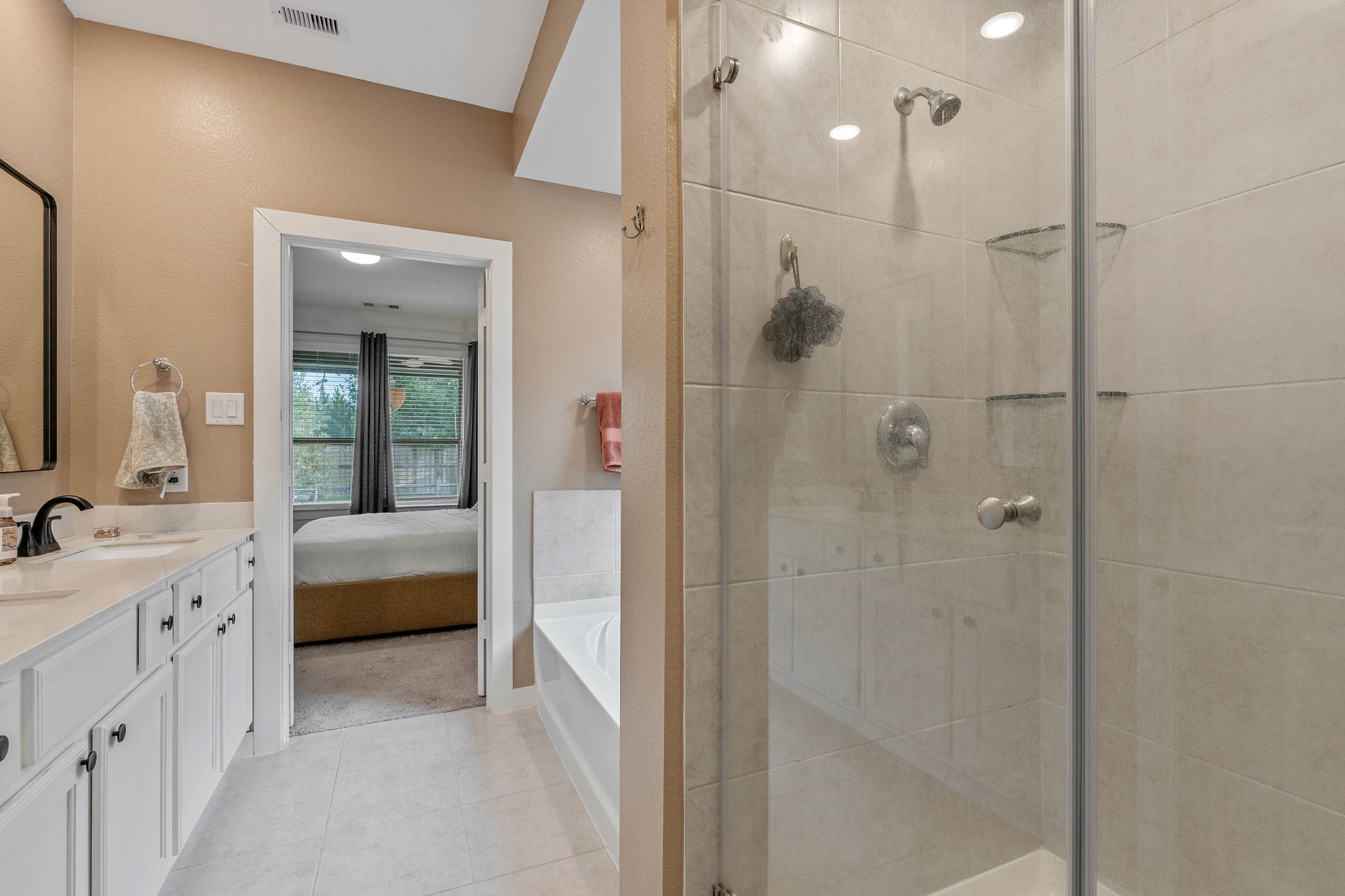 509 Timber Voyage Court Conroe, TX 77304 - Photo 25 of 36 a bathroom with a double vanity sink a large mirror and shower