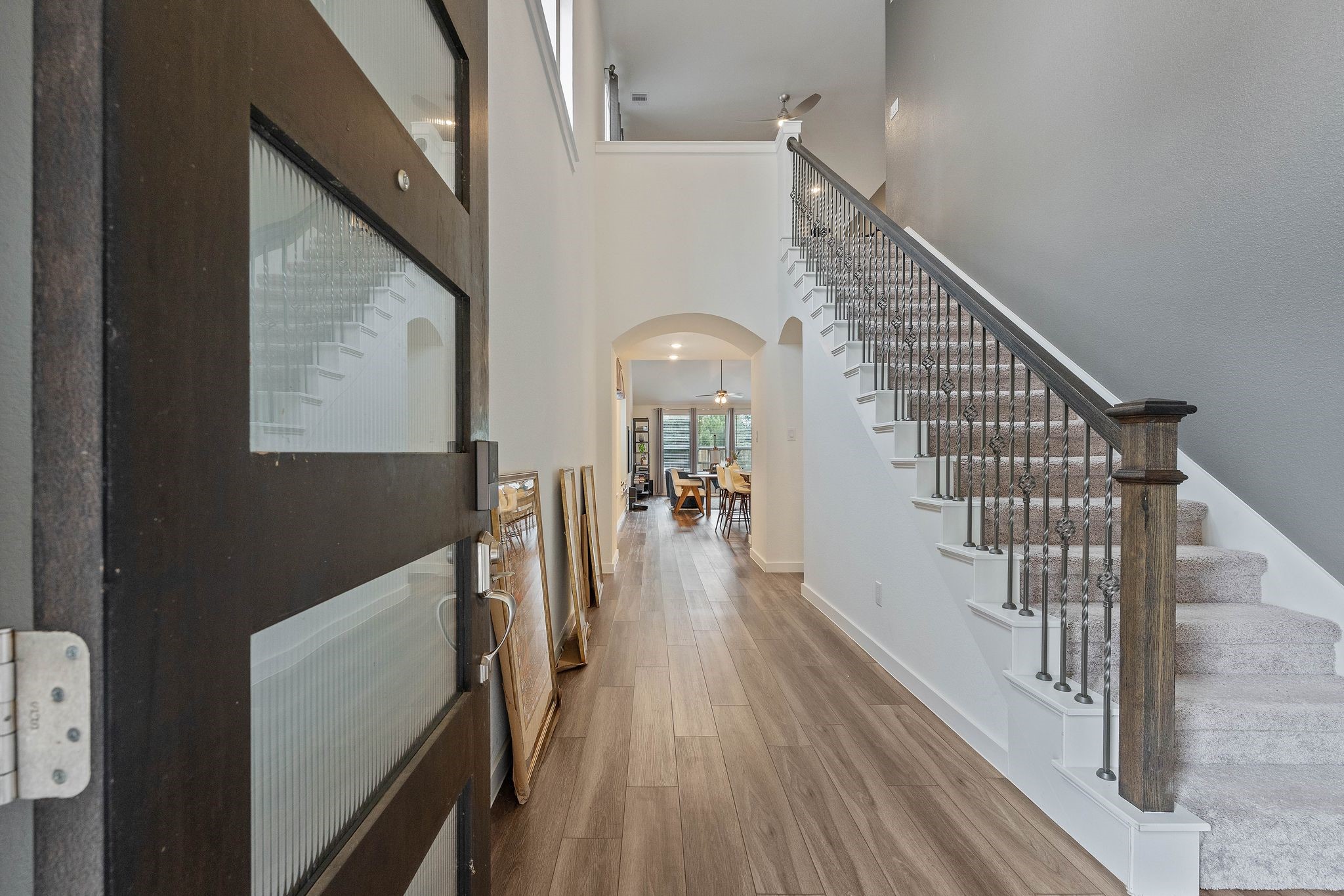 509 Timber Voyage Court Conroe, TX 77304 - Photo 4 of 36 a view of a hallway with wooden floor and staircase