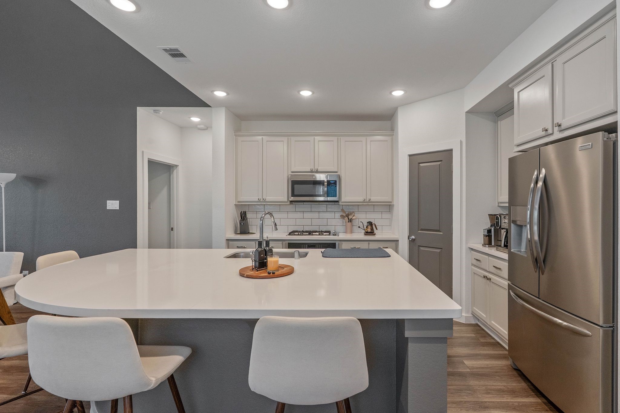 509 Timber Voyage Court Conroe, TX 77304 - Photo 9 of 36 a kitchen with refrigerator a sink and chairs