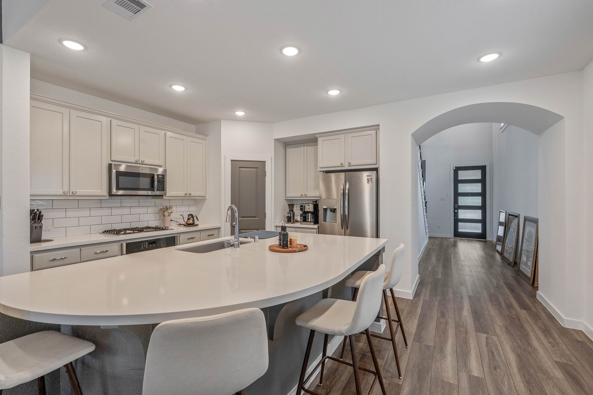 509 Timber Voyage Court Conroe, TX 77304 - Photo 10 of 36 a kitchen with stainless steel appliances a dining table chairs refrigerator and microwave