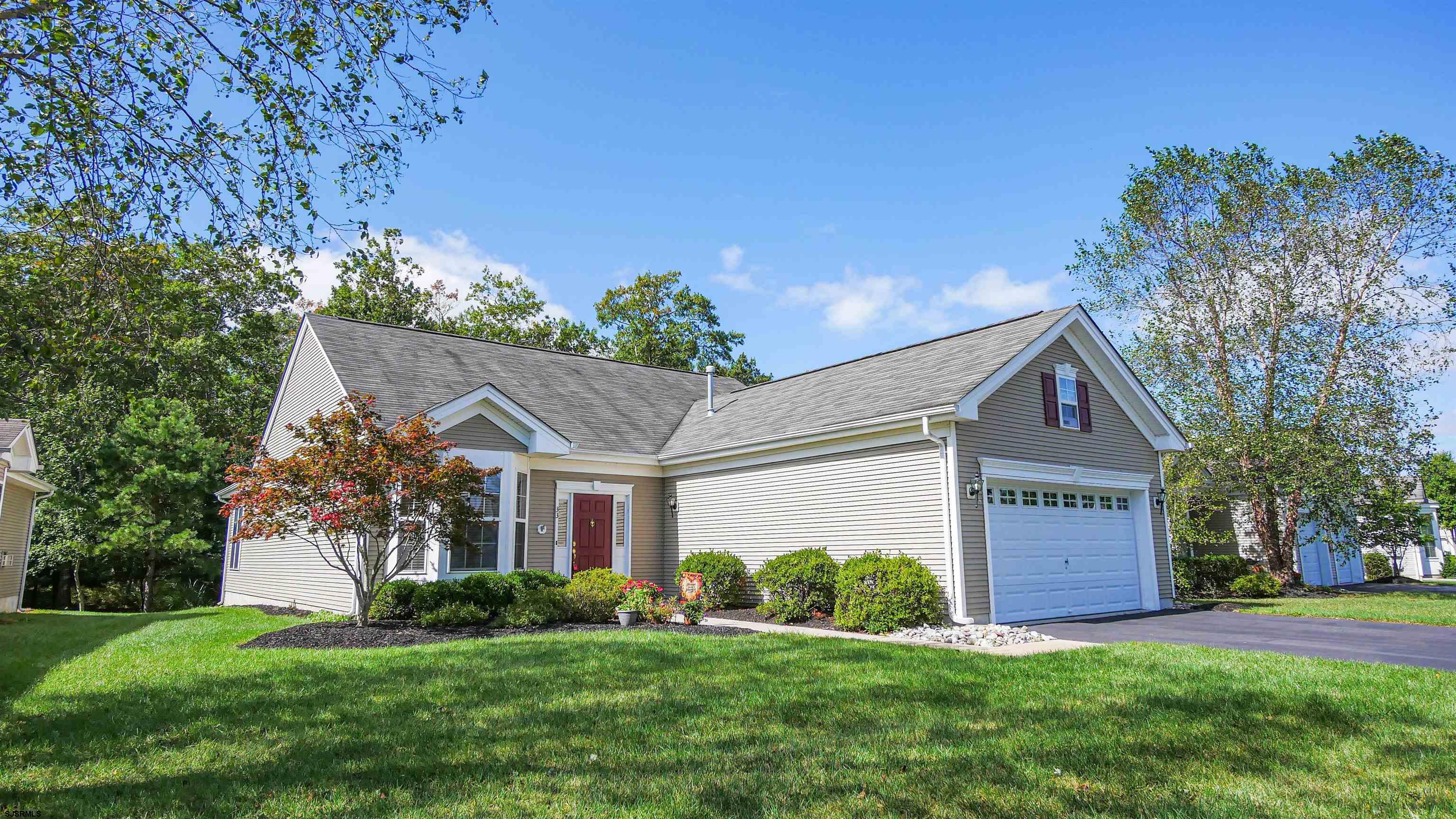 33 Brampton Street Smithville, NJ 08205 - Photo 1 of 37 a front view of a house with a yard and garage