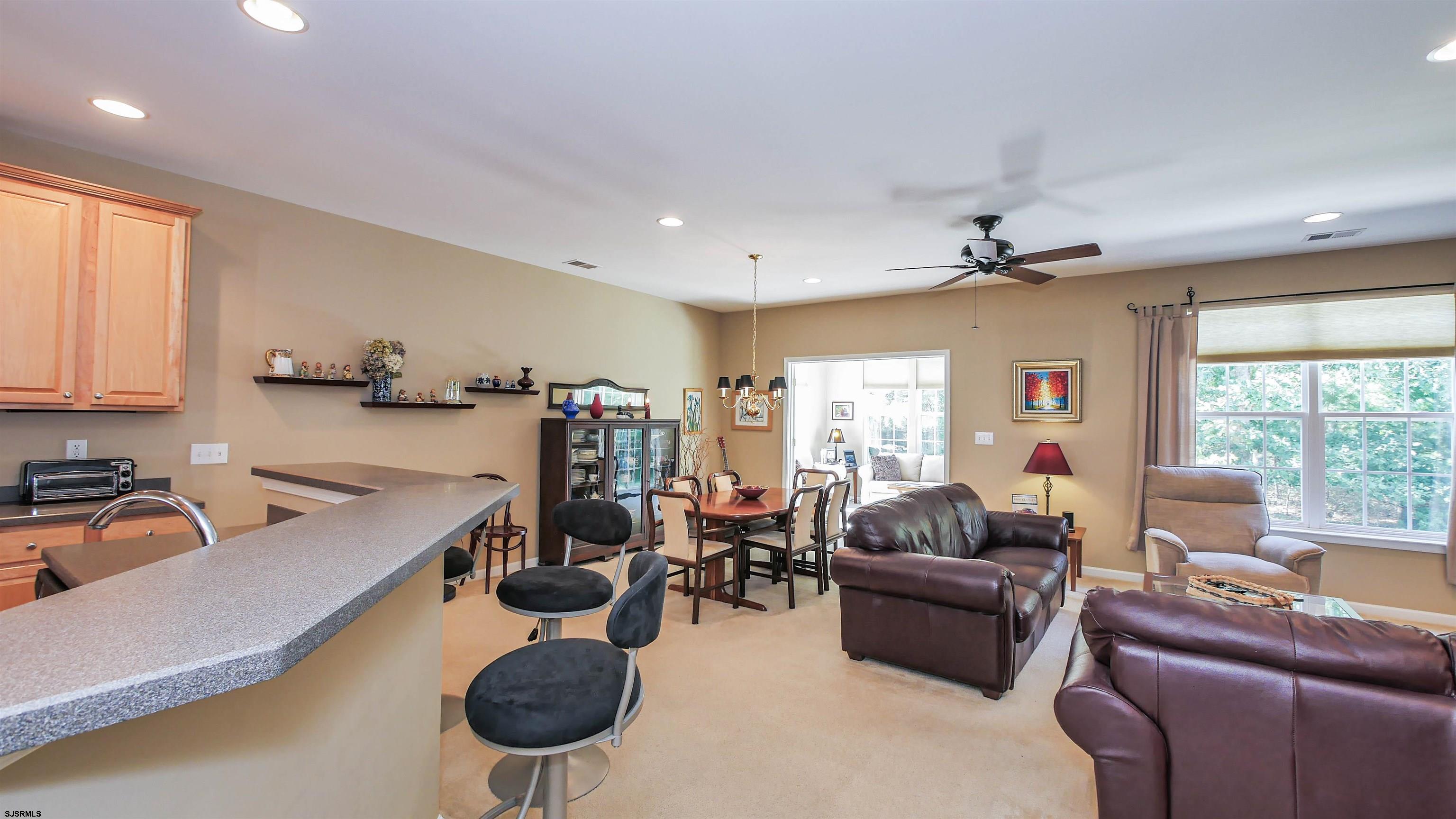 33 Brampton Street Smithville, NJ 08205 - Photo 13 of 37 a living room with furniture a chandelier and a large window