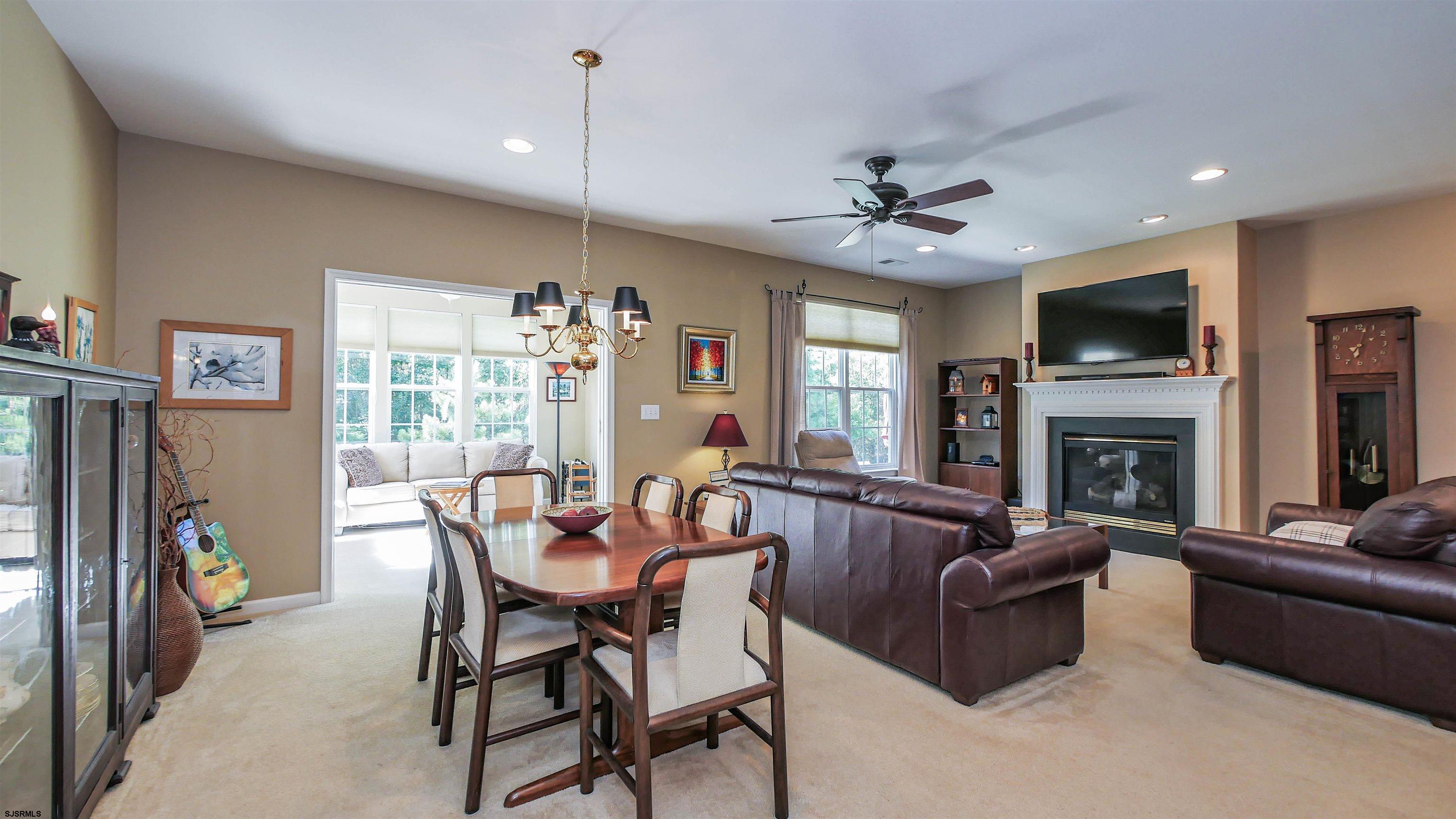 33 Brampton Street Smithville, NJ 08205 - Photo 14 of 37 a living room with furniture a flat screen tv and a fireplace