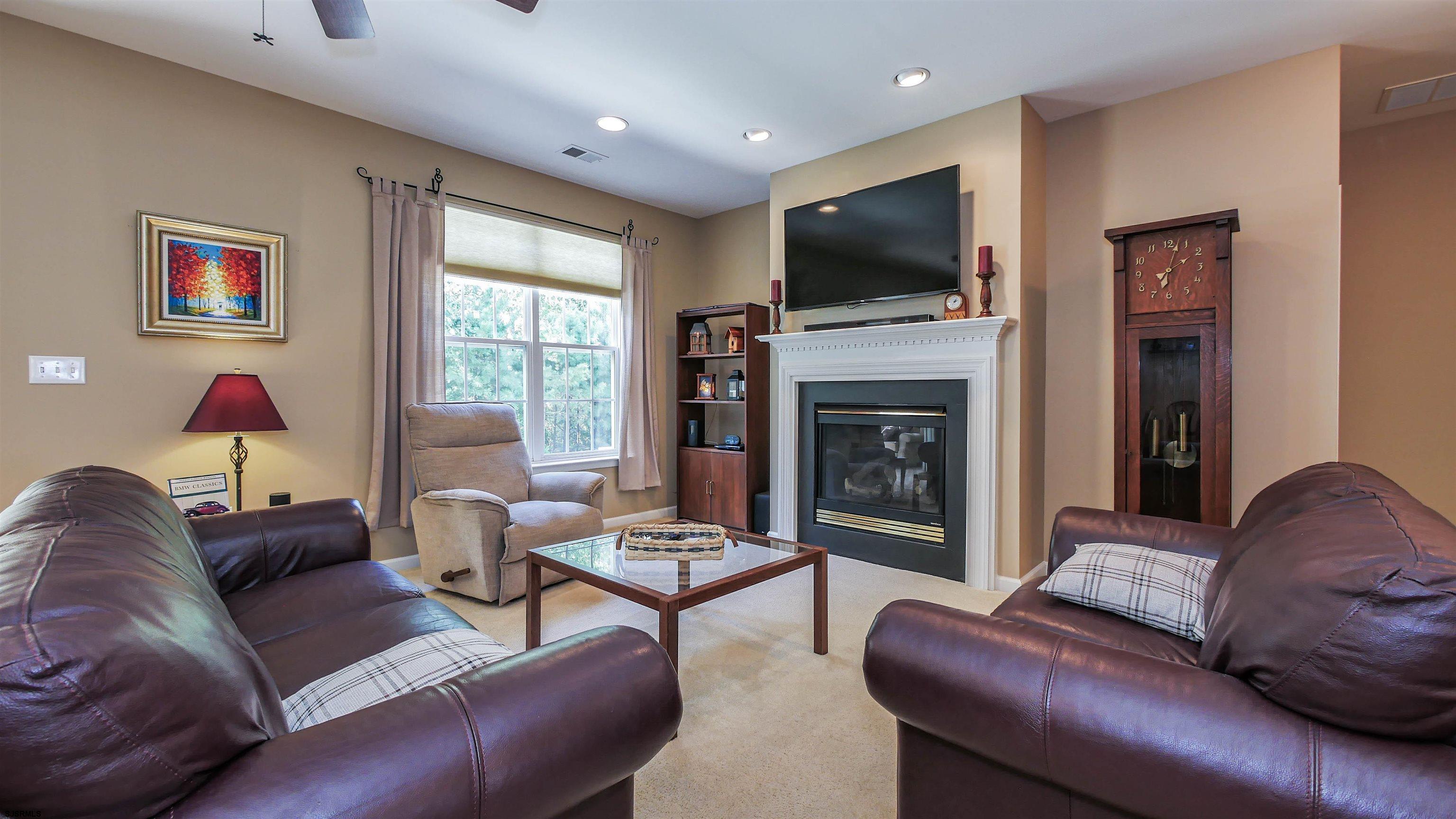33 Brampton Street Smithville, NJ 08205 - Photo 15 of 37 a living room with furniture flat screen tv and a fireplace