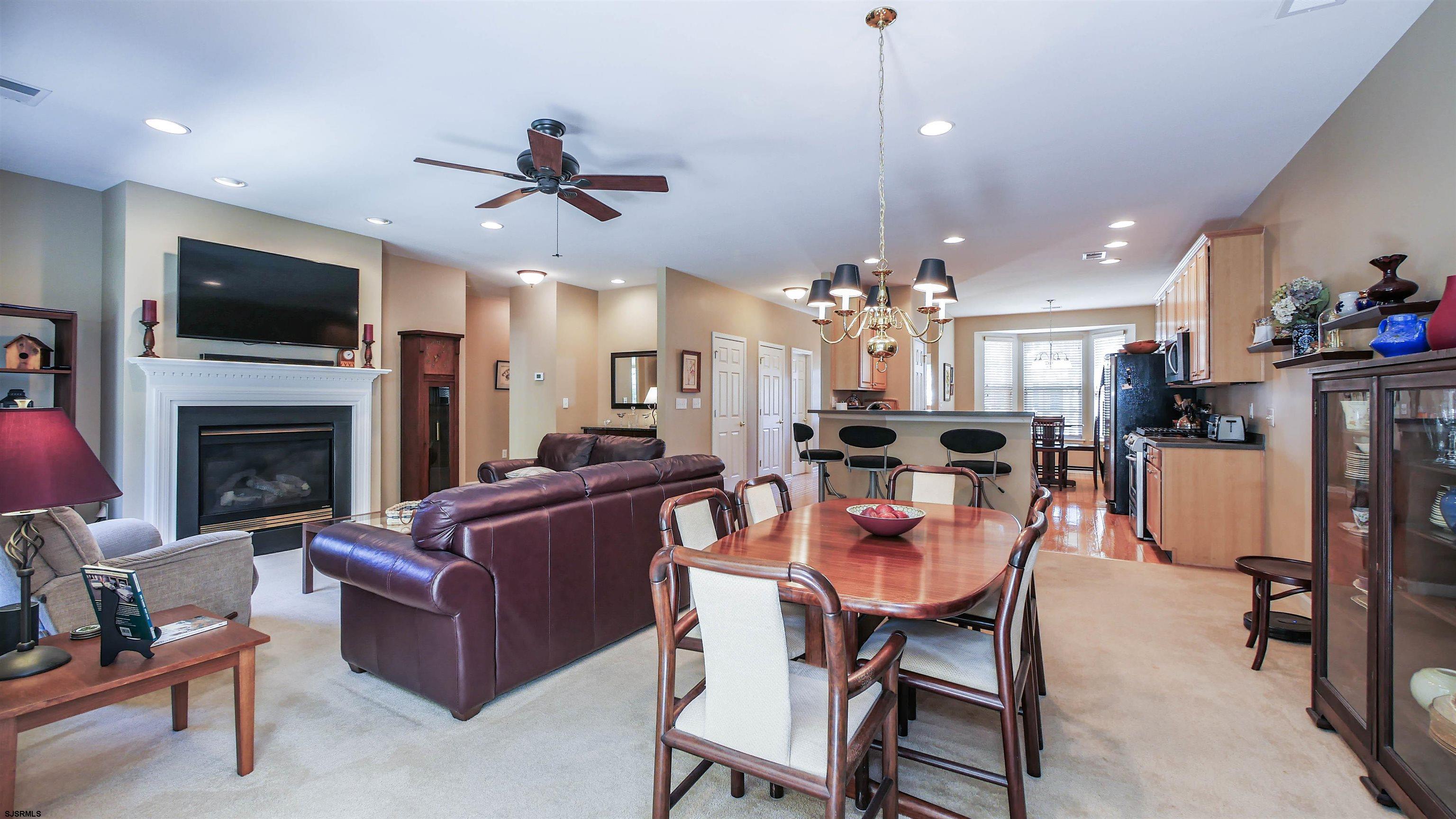 33 Brampton Street Smithville, NJ 08205 - Photo 20 of 37 a living room with furniture a flat screen tv and kitchen view
