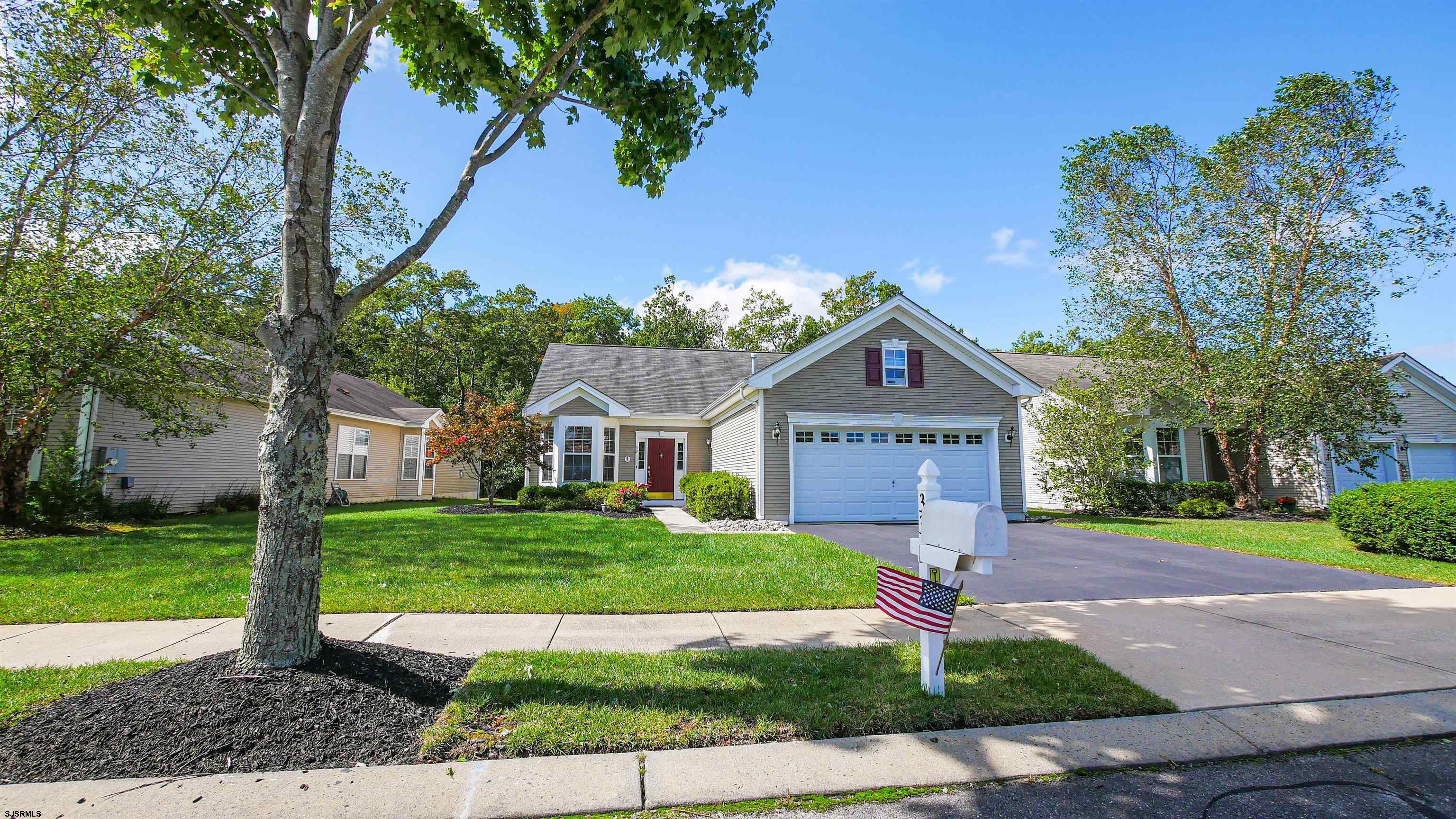 33 Brampton Street Smithville, NJ 08205 - Photo 2 of 37 a front view of a house with a yard and garage