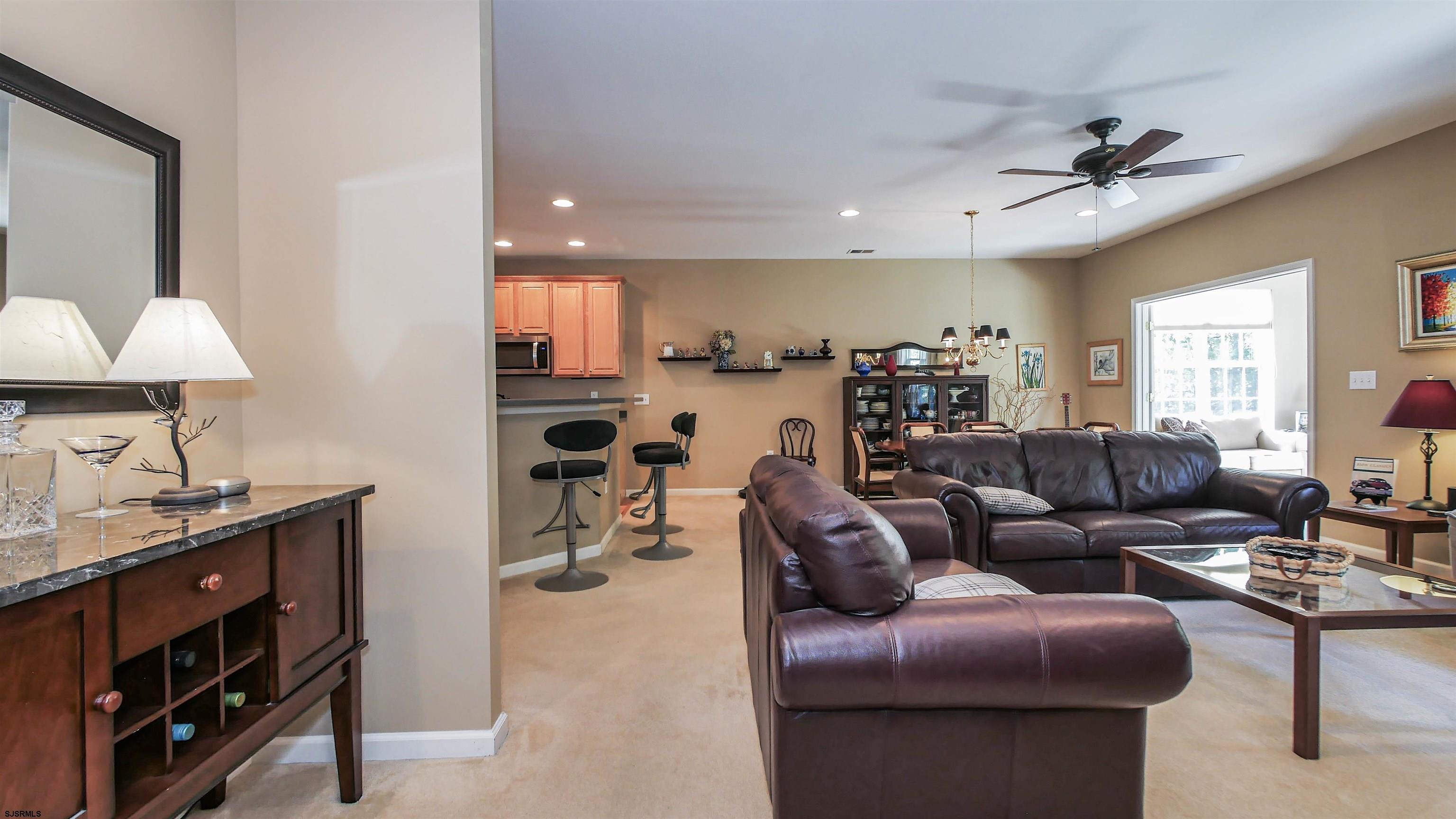 33 Brampton Street Smithville, NJ 08205 - Photo 21 of 37 a living room with furniture and a chandelier
