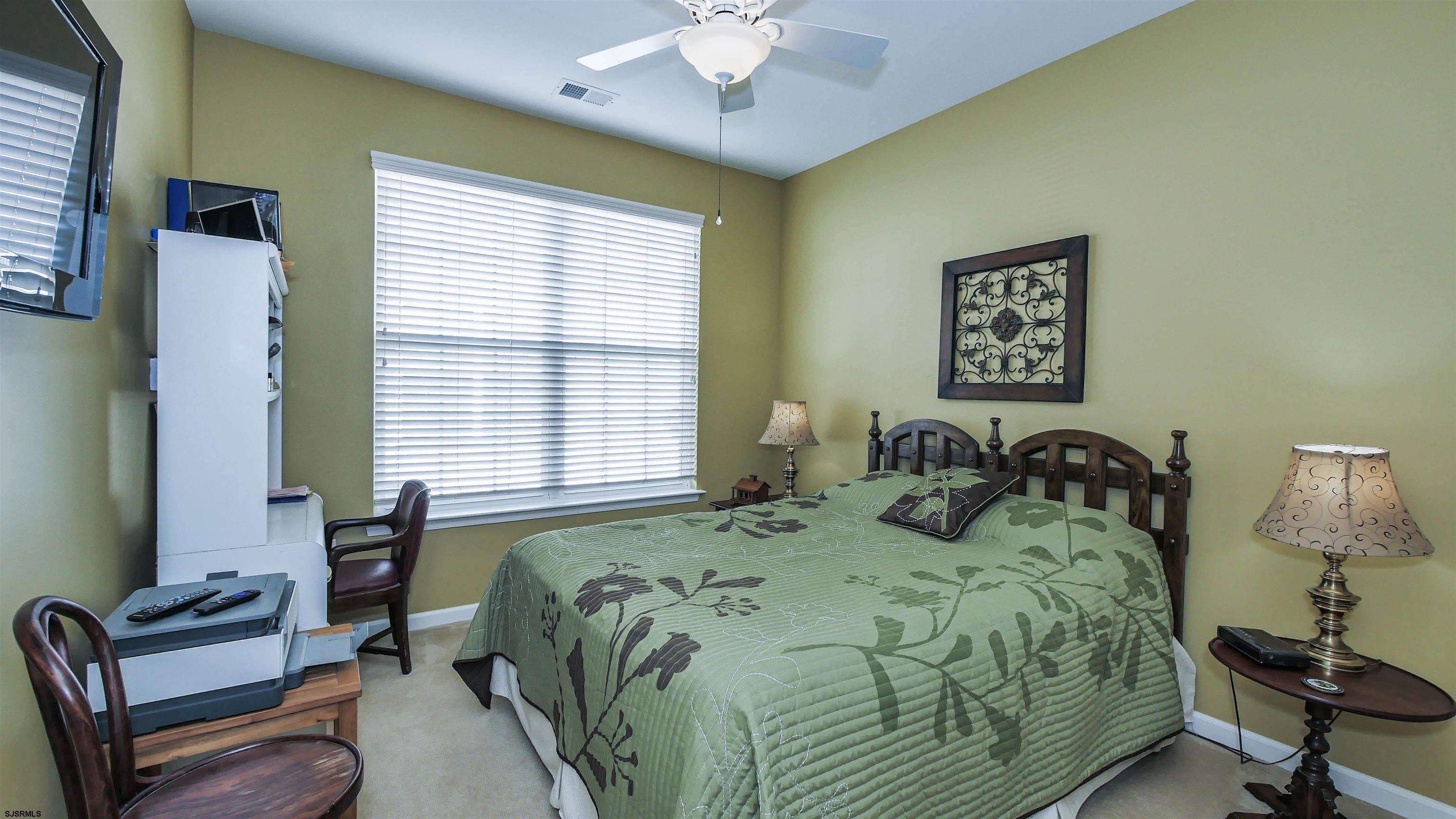 33 Brampton Street Smithville, NJ 08205 - Photo 22 of 37 a bedroom with a bed and a chandelier